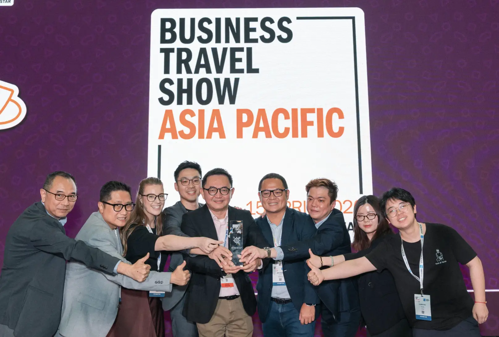Winners of Business Travel Show Asia Pacific Innovation Faceoff pose with award on stage in Singapore