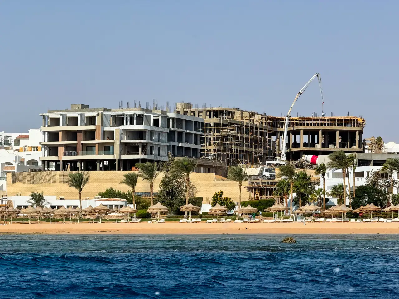 Hotel construction site on the Red Sea coast in Sharm El Sheikh, Egypt, showing new resort development along the beachfront