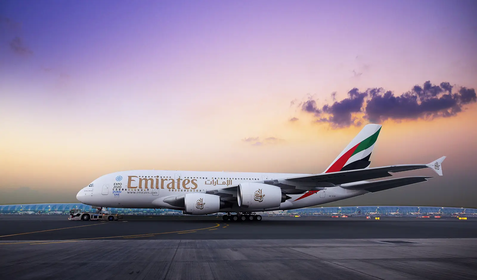 Emirates Airbus A380 aircraft on airport runway at sunset in Dubai