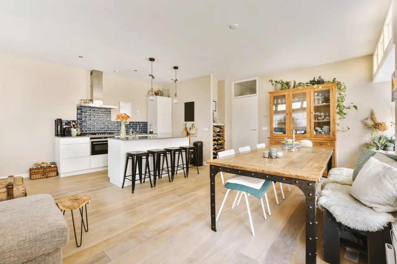 Open-plan furnished apartment with kitchen, dining table, and living area designed for extended stay travelers