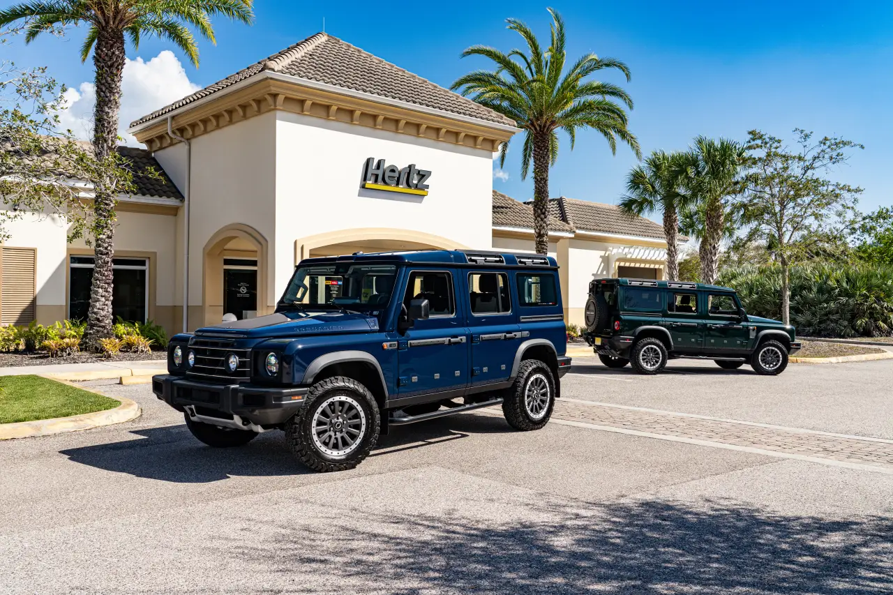 INEOS Grenadier 4x4 vehicles parked outside a Hertz rental location, showcasing new premium off-road rentals at US airports