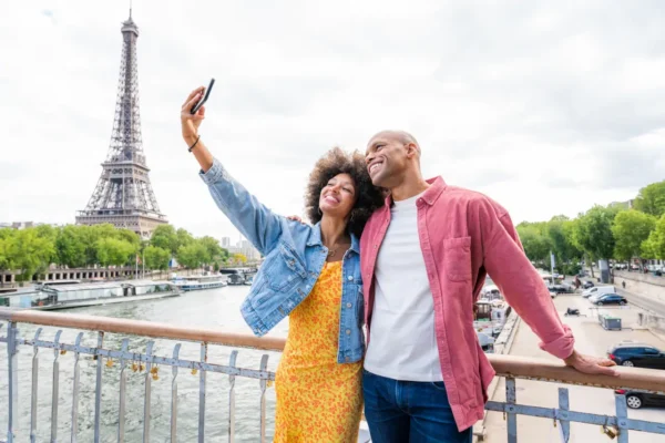 Couple taking selfie near Eiffel Tower Paris during city visit