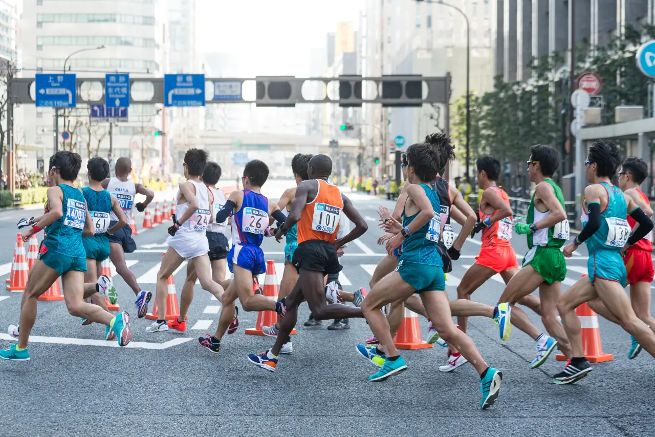 Runners competing in the Tokyo Marathon through central Tokyo city streets