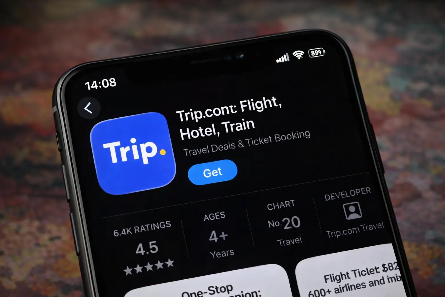 Trip.com travel booking app displayed on an iPhone screen showing flight, hotel and train booking options