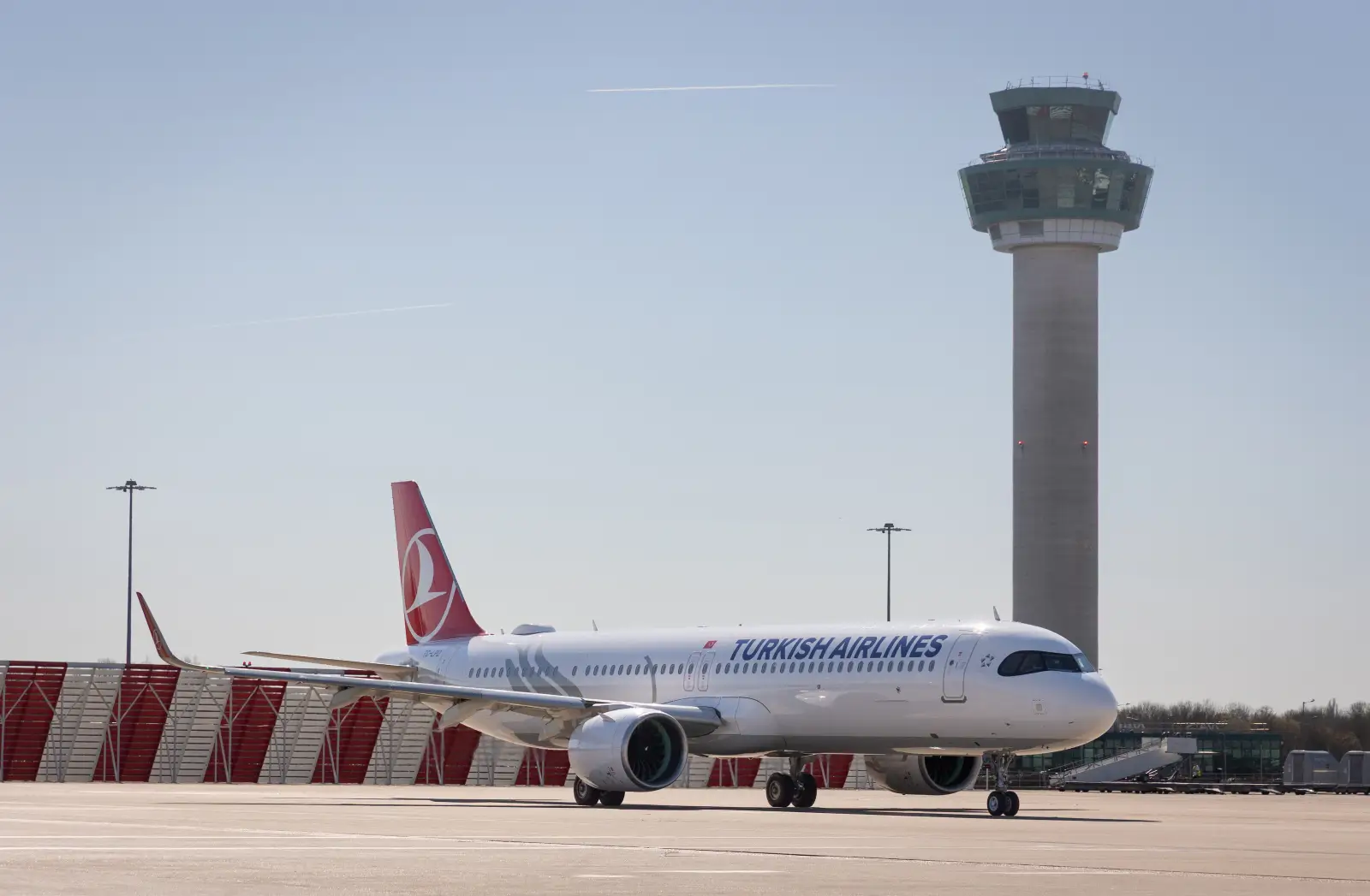 Turkish Airlines aircraft on runway at London Stansted Airport with control tower