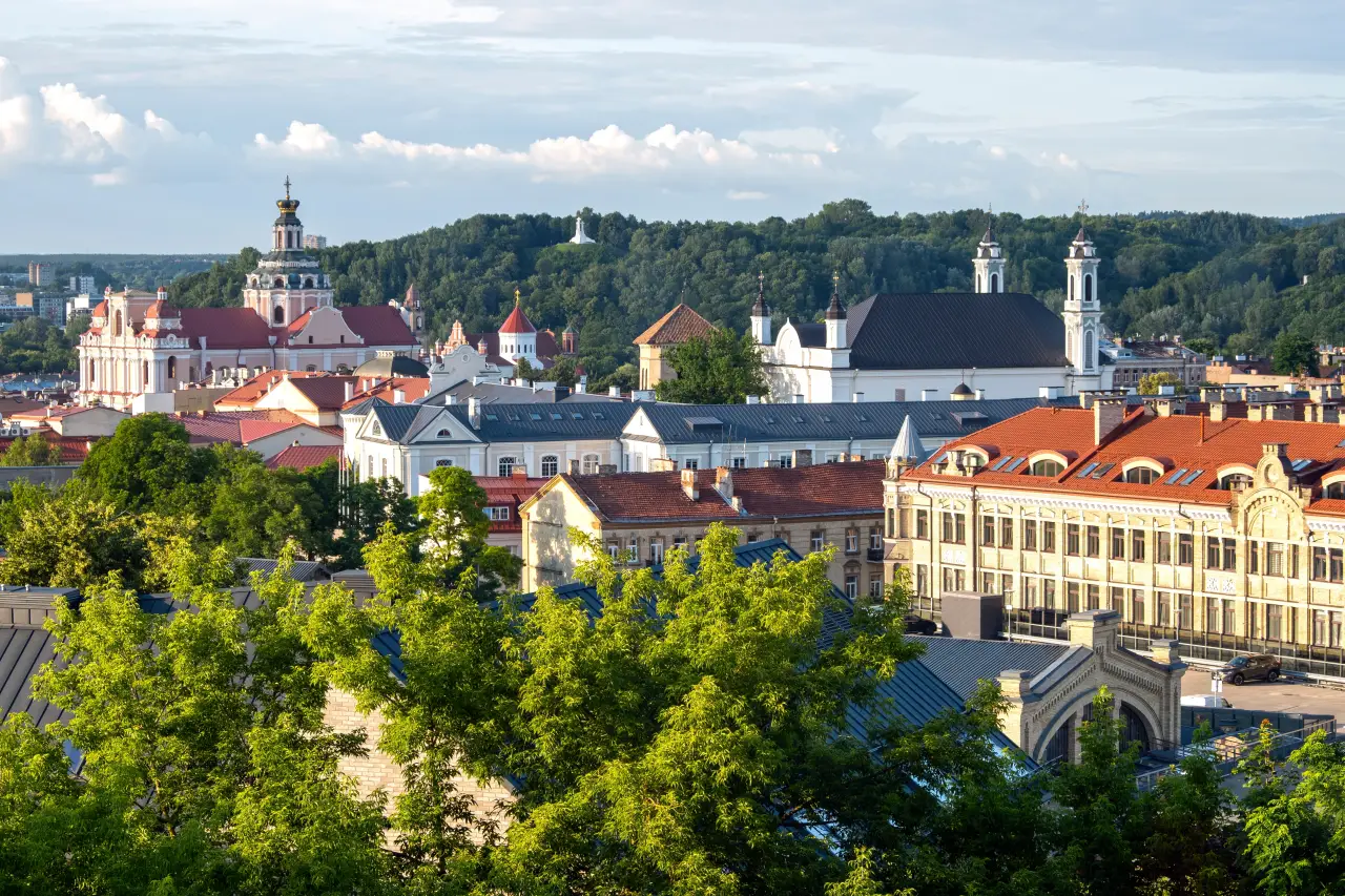 Panoramic summer view of Vilnius Old Town with Church of St. Casimir and historic rooftops in Lithuania