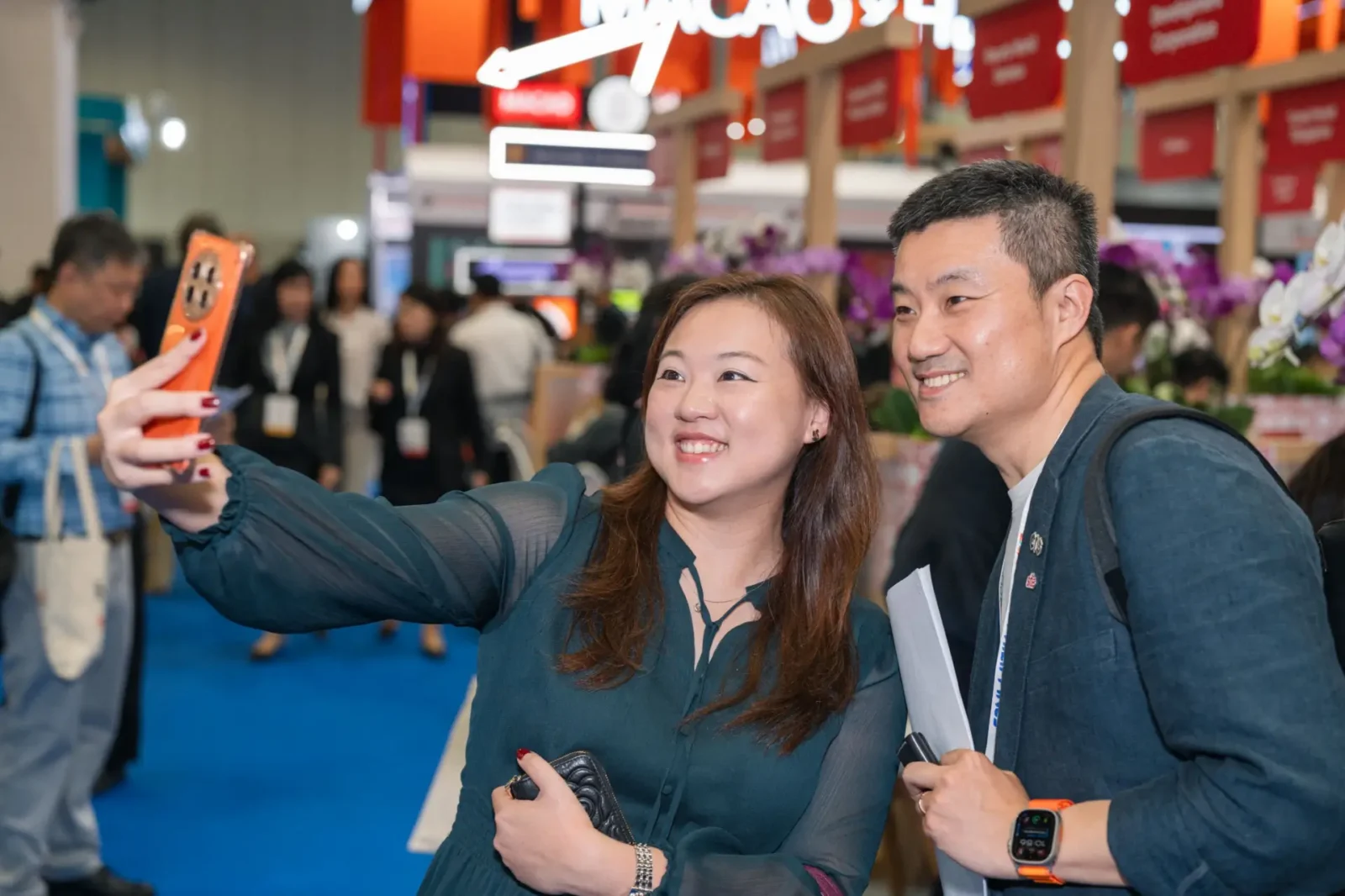 Key Focus On ‘Ai In Action’ In Corporate Travel Planning At Business Travel Show Asia Pacific 2 ttendees taking a selfie at Business Travel Show Asia Pacific exhibition with trade stands in the background
