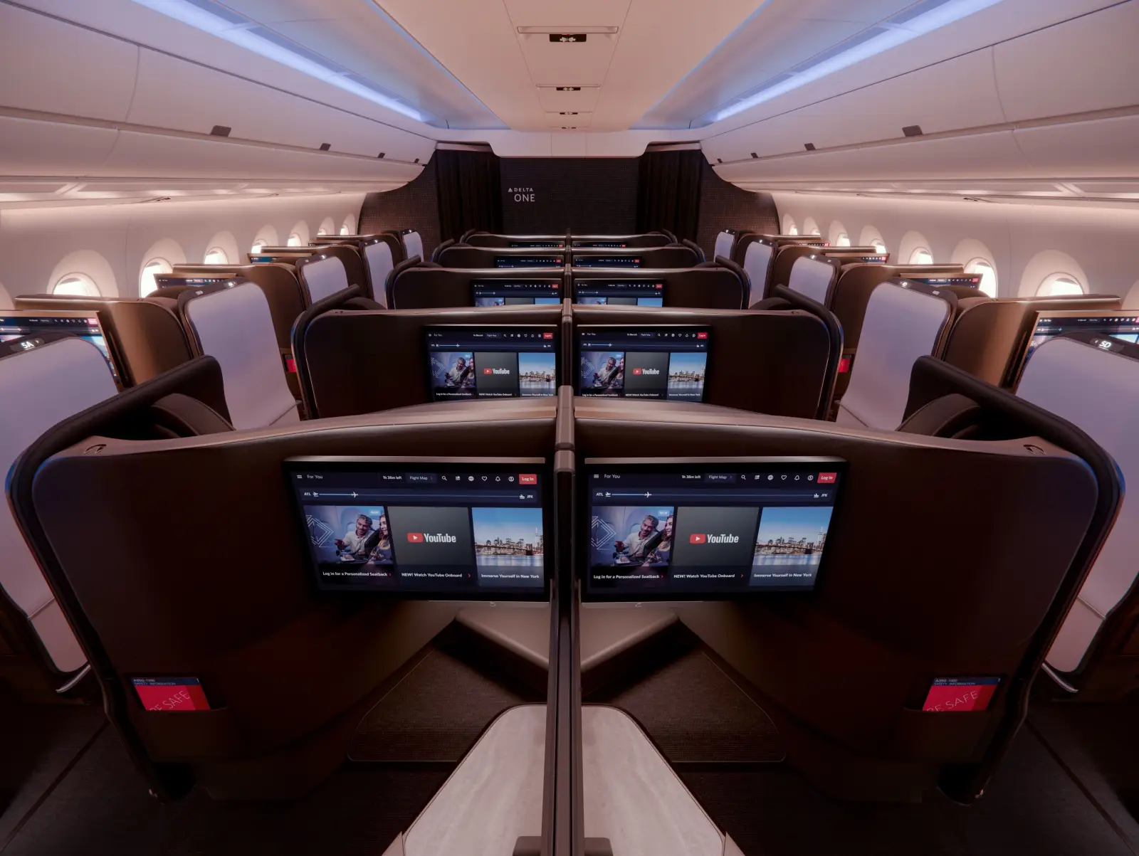 Delta One business class cabin on Airbus A350-1000 with private suites, large seatback screens and modern premium seating layout