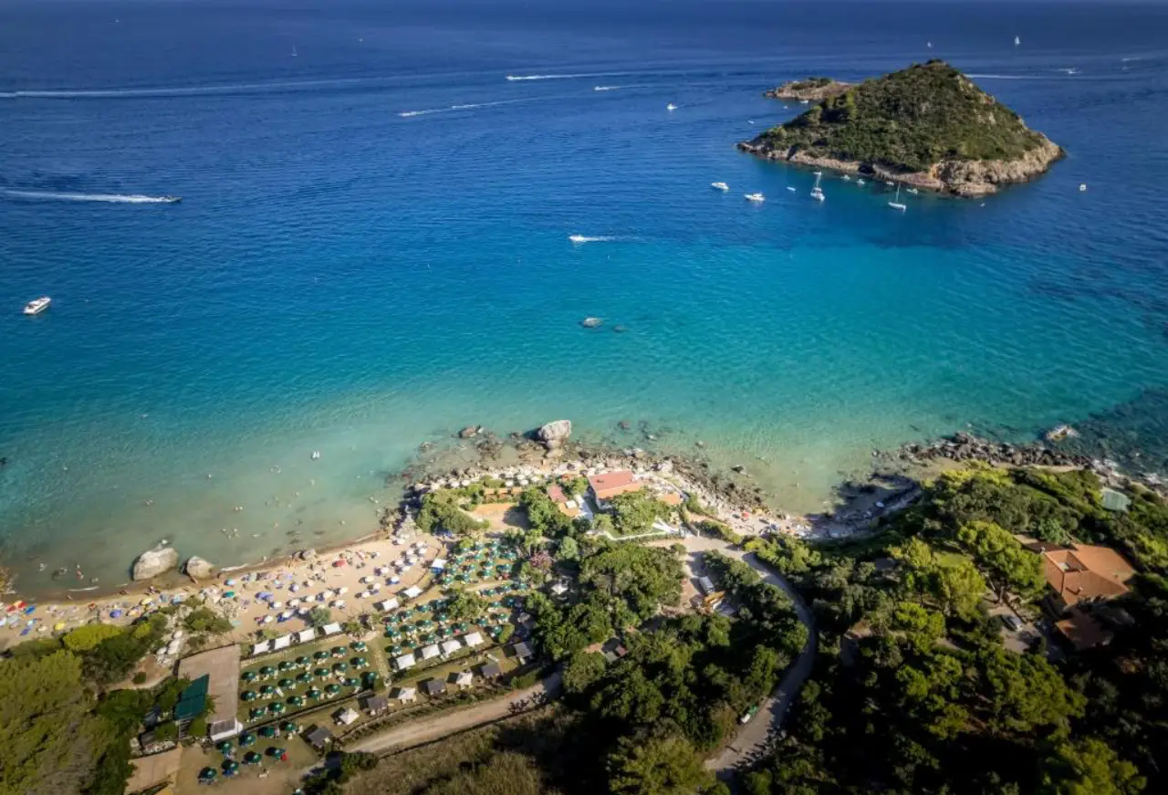 Aerial view of Argentario coastline with beach club, turquoise sea and small island offshore