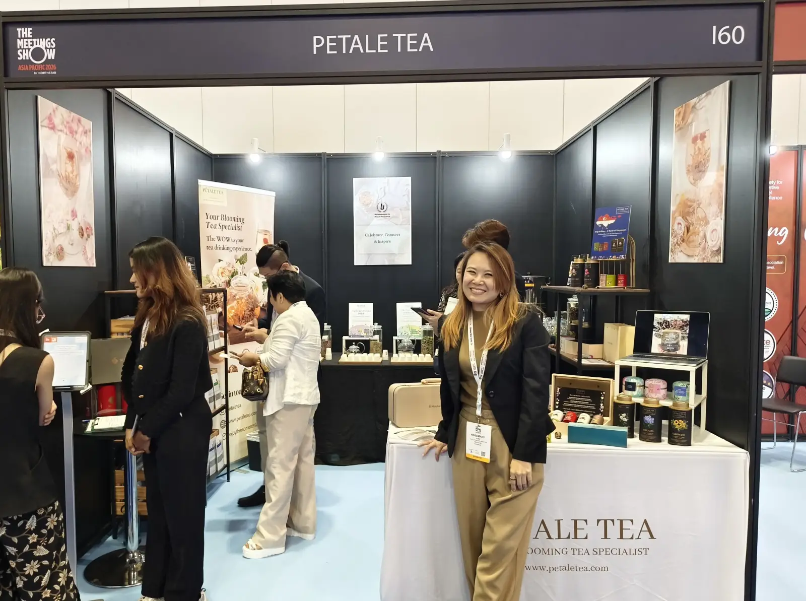 Petale Tea booth at TMS APAC 2026 Singapore showcasing blooming tea products and wellness offerings with visitors and founder present
