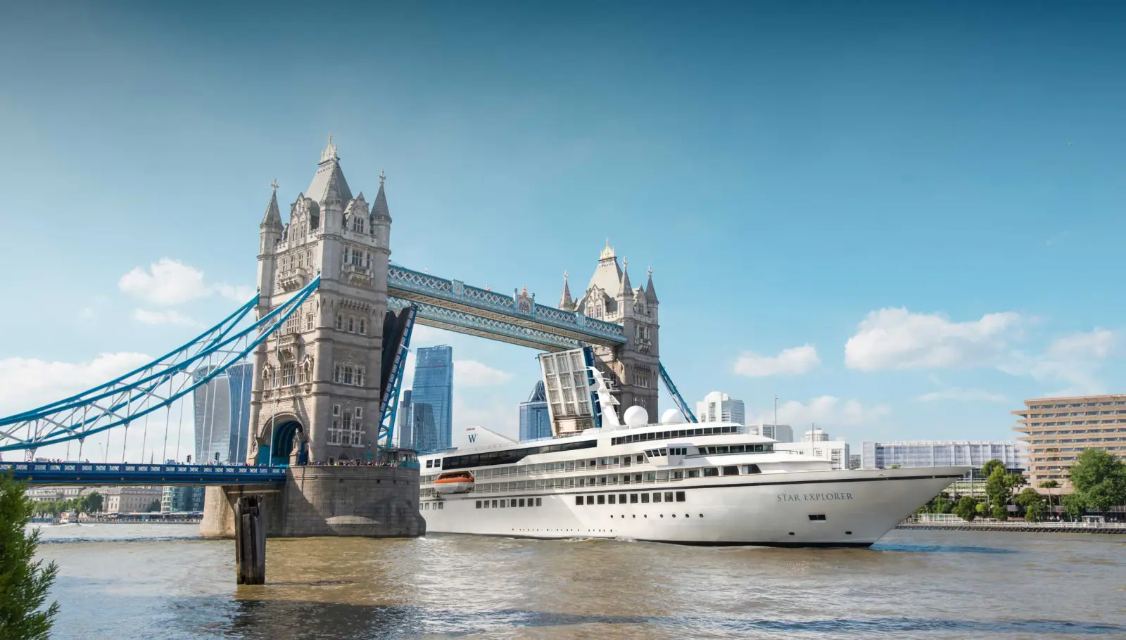 Modern cruise ship Star Explorer passing under London Tower Bridge on the River Thames in London on a clear day