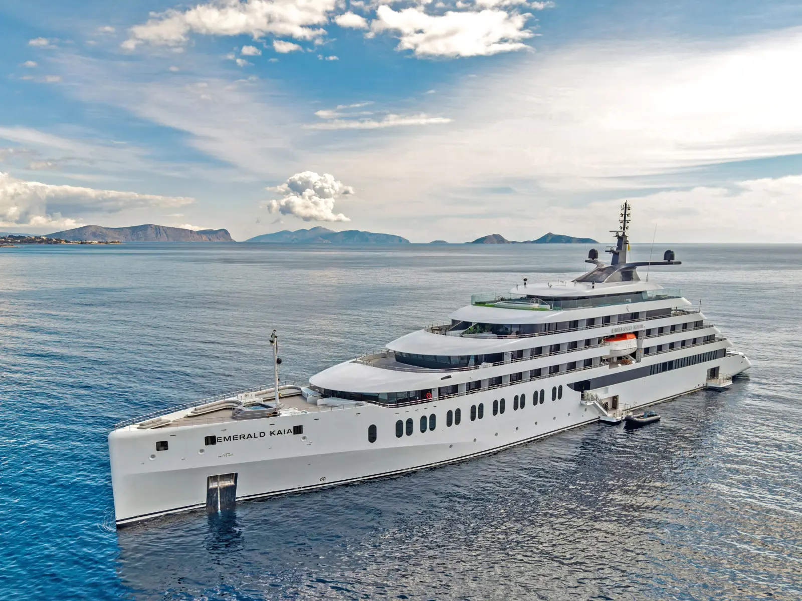 Emerald Kaia luxury superyacht sailing in calm Mediterranean waters with islands in the background