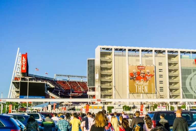 Crowds of fans walking toward the entrance of Levi’s Stadium in Santa Clara on a clear day before an event