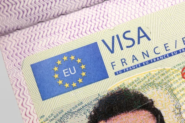 Schengen visa sticker issued by France displayed in passport showing European Union travel authorization