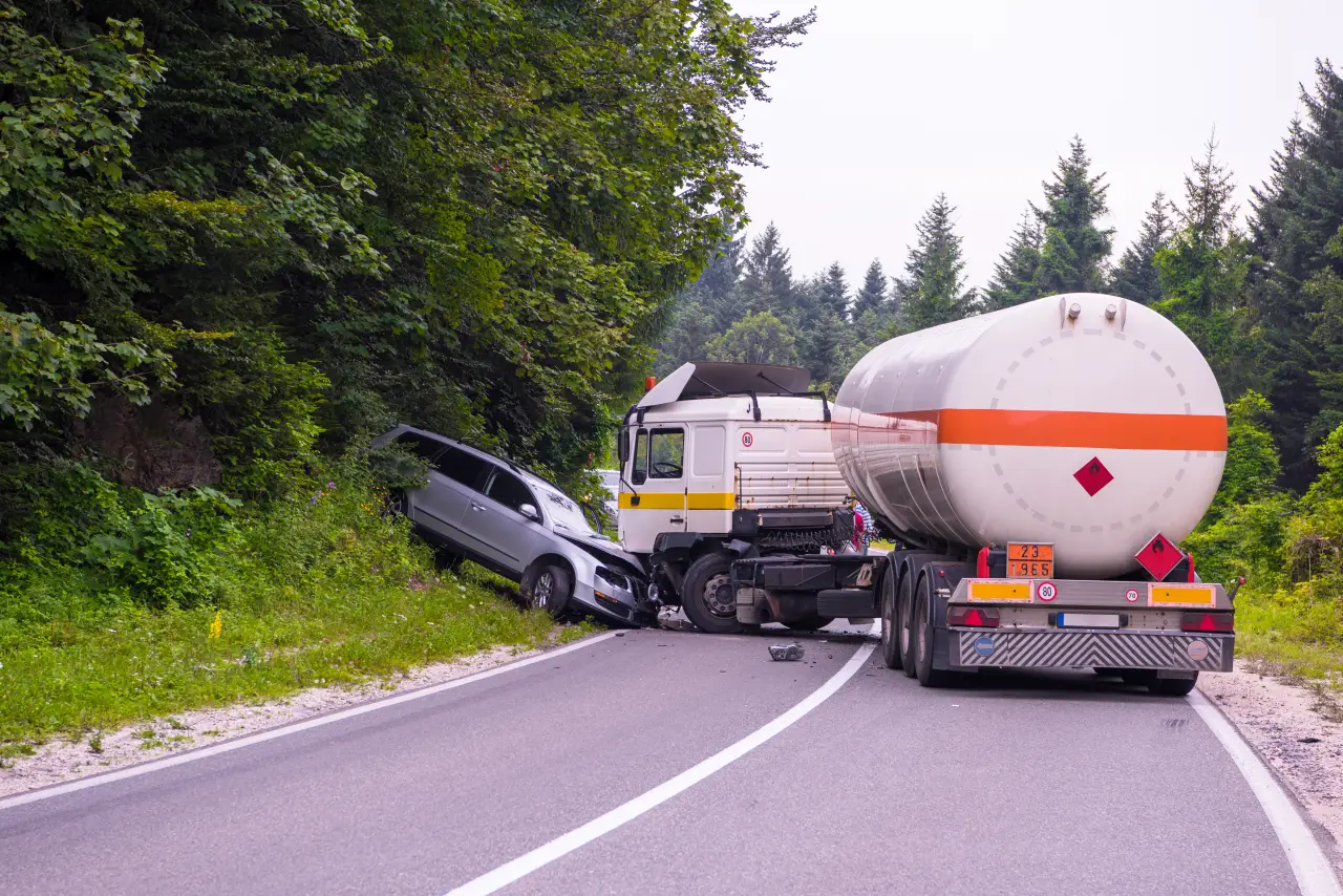 Why Highway Truck Accidents Increase During Holiday Travel Seasons 3 Partially obscured tanker truck on road seen through damaged or peeling surface texture