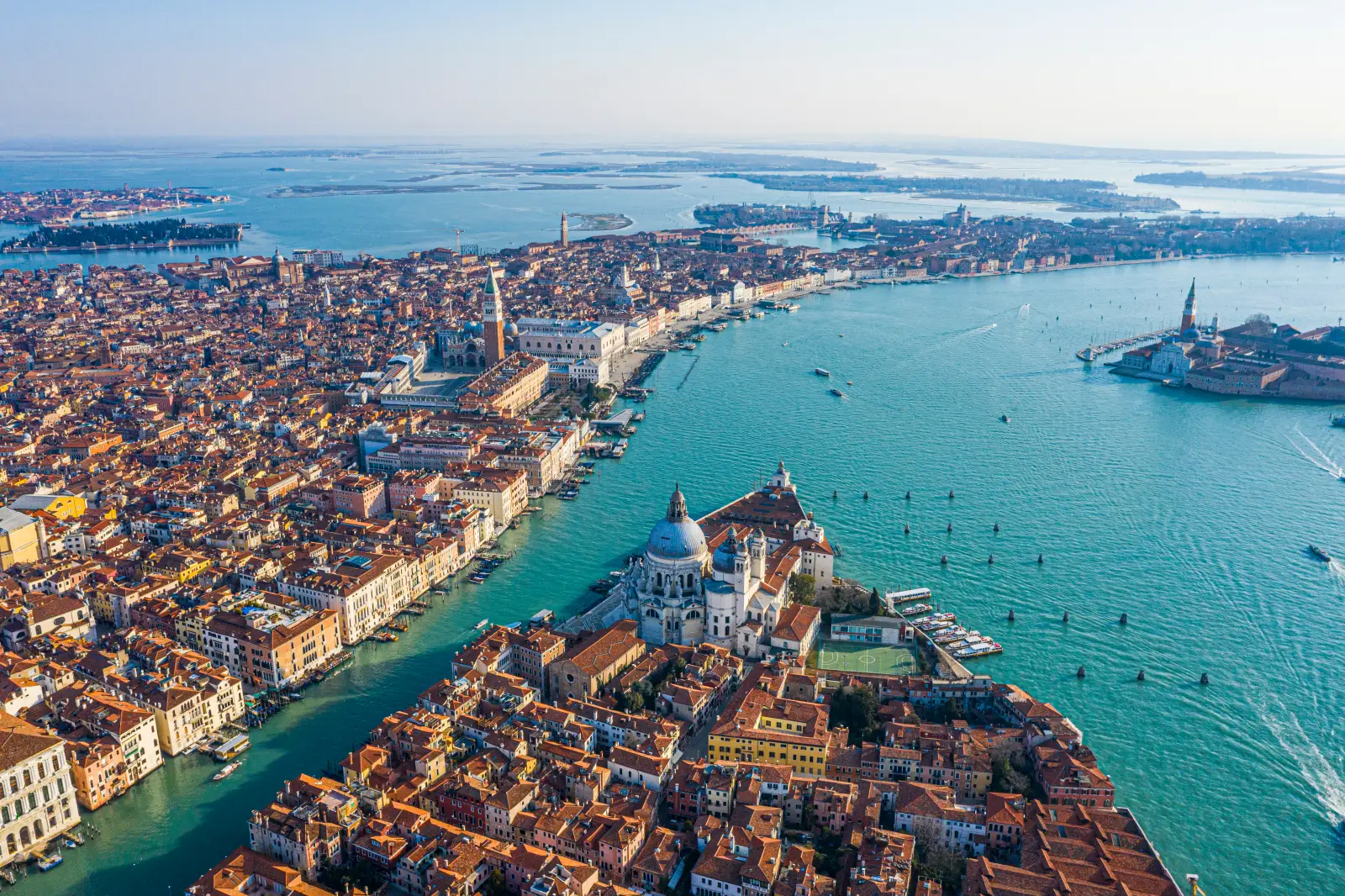 Aerial view of Venice with Grand Canal, historic buildings, and Santa Maria della Salute along the lagoon