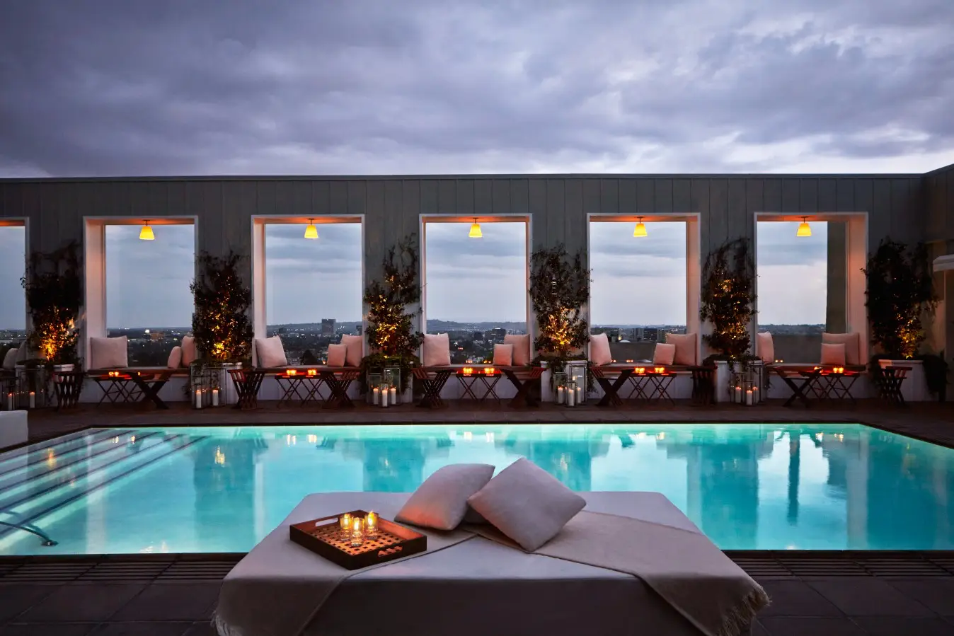 The Valorian Los Angeles, Curio Collection By Hilton Opens, Taking Over From Mondrian Los Angeles 6 White Rabbit Sky Lounge rooftop pool at The Valorian Los Angeles at sunset with candlelit seating and panoramic city views