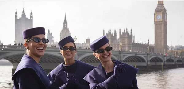 Riyadh Air cabin crew posing beside the River Thames with Big Ben and the Houses of Parliament in London