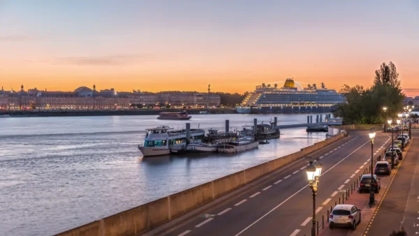 Cruise ship docked on the Garonne River in Bordeaux at sunset