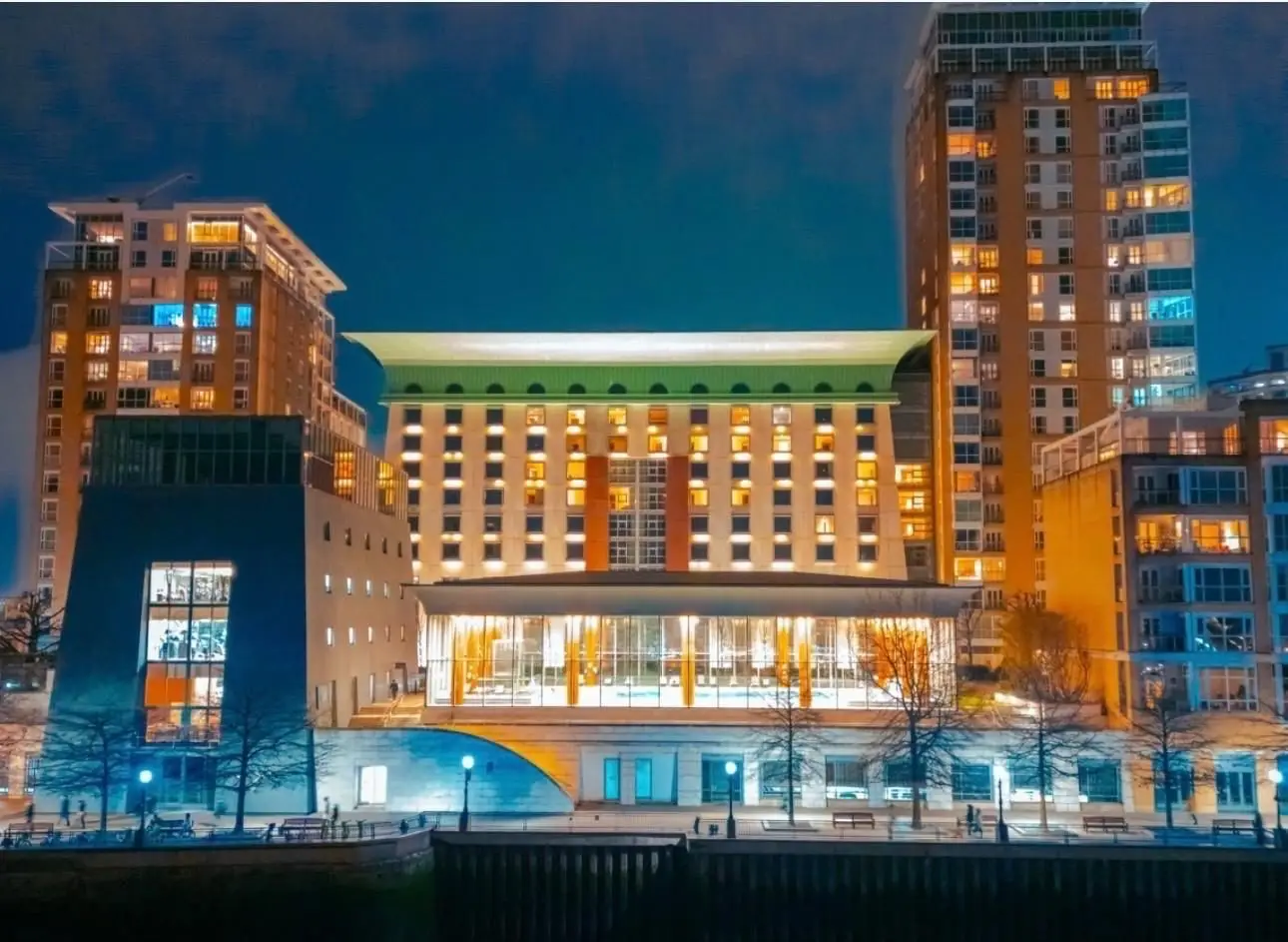 Canary Riverside Plaza hotel in Canary Wharf illuminated at night beside the River Thames ahead of its Vignette Collection by IHG opening in London.