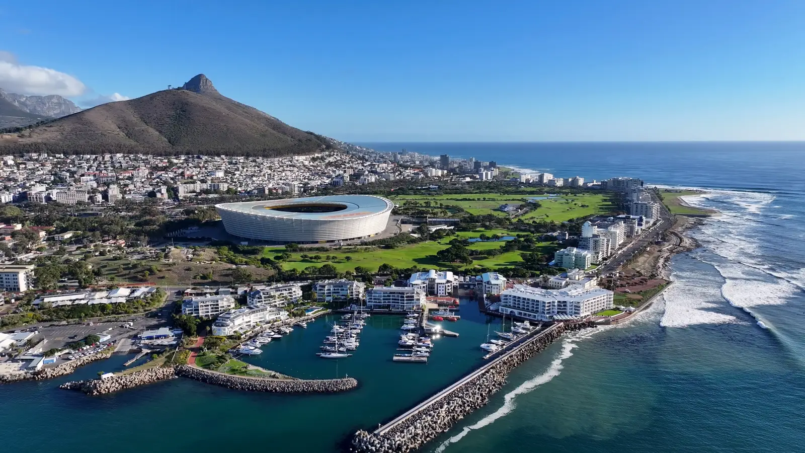 Aerial view of Cape Town coastline with Cape Town Stadium, marina, and Table Mountain in the background