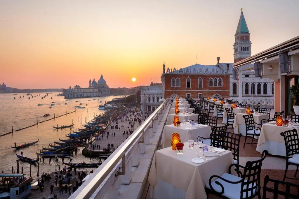 The Most Anticipated Hotel Openings In Venice In 2026 6 Rooftop terrace restaurant at Danieli, a Four Seasons Hotel, Venice, with lagoon views at sunset