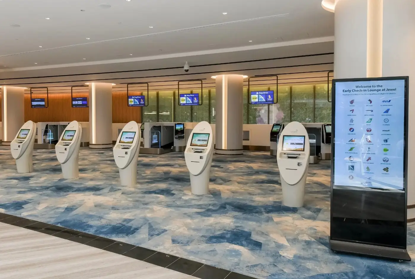 Jewel Changi Airport: Key Highlights Of This Iconic Lifestyle Destination (Part 1) 5 Early check-in facility at Jewel Changi Airport in Singapore featuring self-service kiosks and automated baggage drop counters