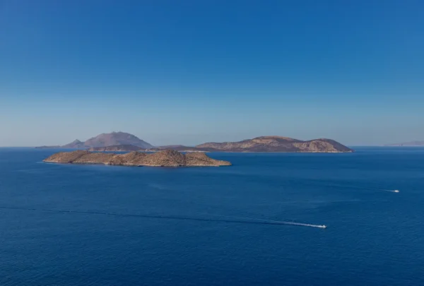 Rocky Dodecanese islands of Makri and Alimia surrounded by deep blue Aegean Sea under a clear sky