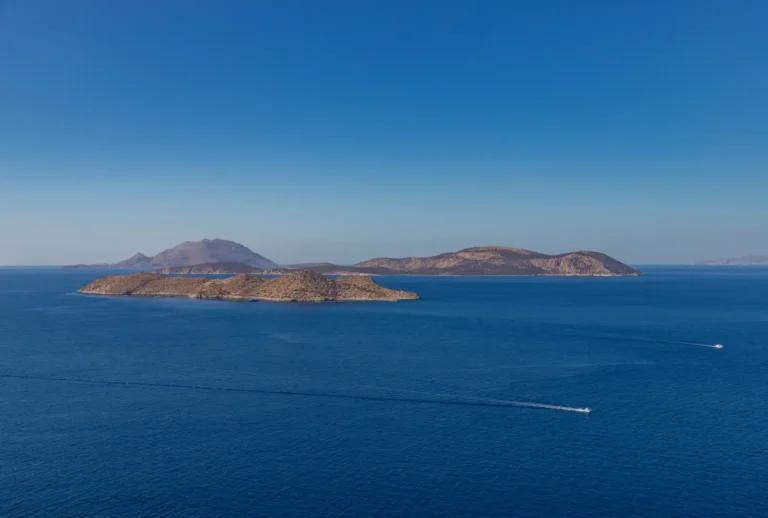 Rocky Dodecanese islands of Makri and Alimia surrounded by deep blue Aegean Sea under a clear sky
