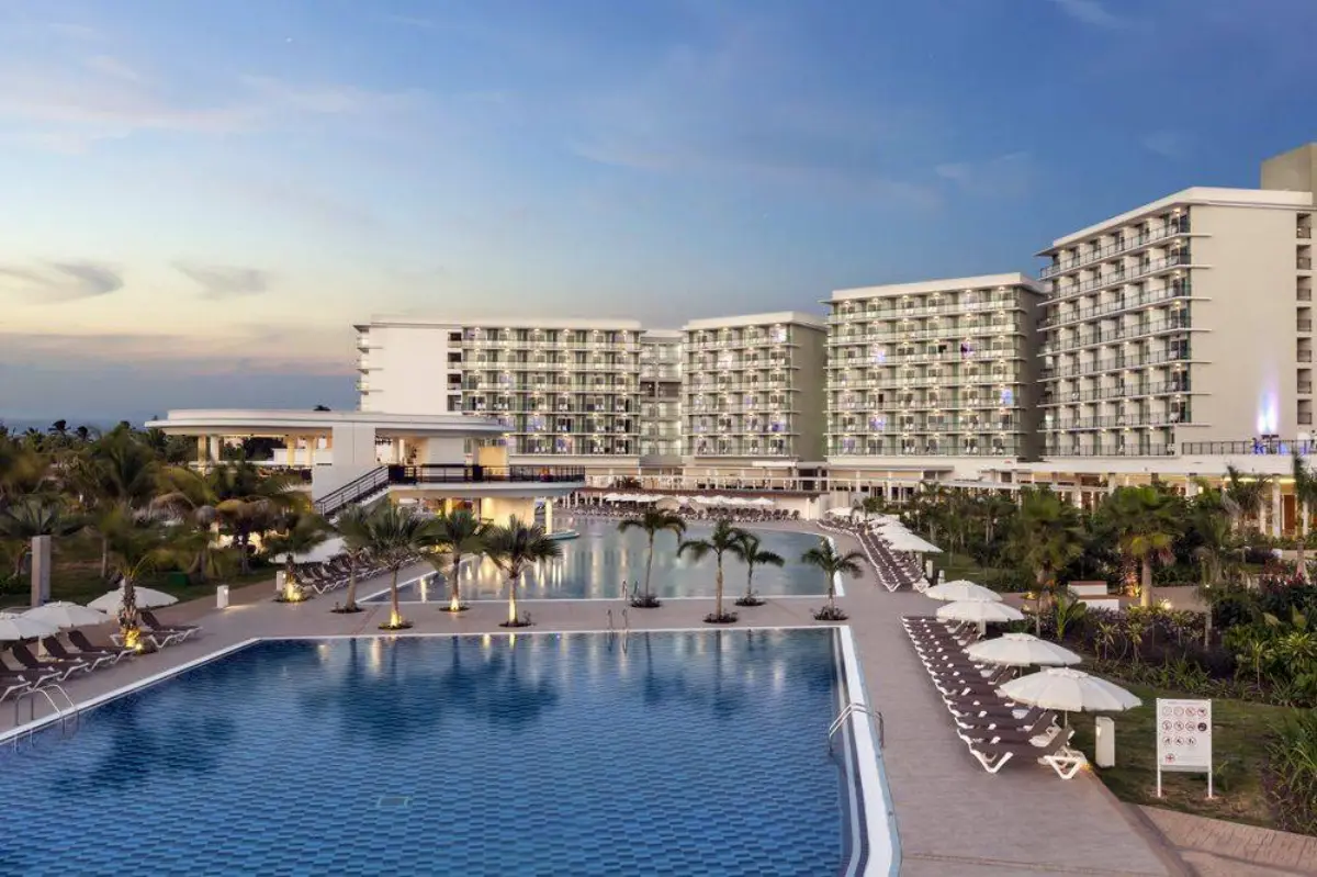 Luxury beachfront resort hotel in Varadero, Cuba, with large swimming pools and modern accommodation buildings at sunset.