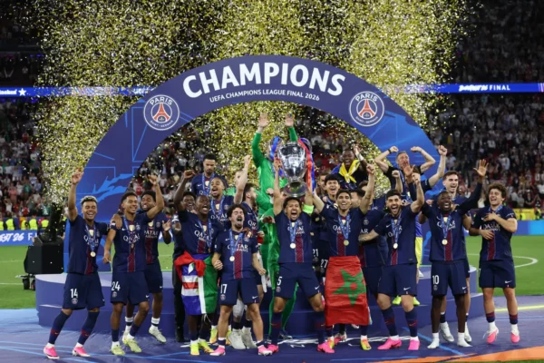 PSG players celebrate winning the 2026 UEFA Champions League final in Budapest with the trophy and gold confetti at Puskás Aréna.