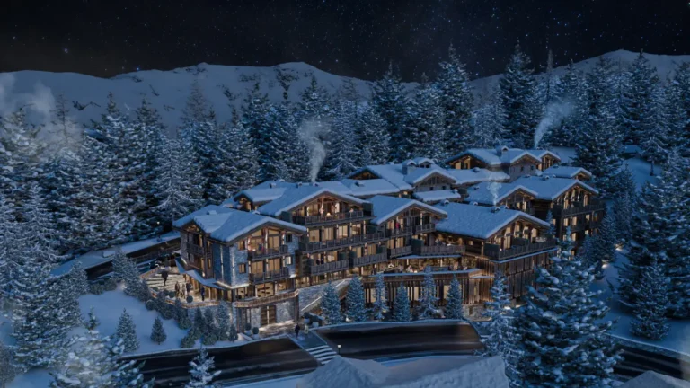 Raffles Courchevel alpine resort at night surrounded by snow-covered pine trees