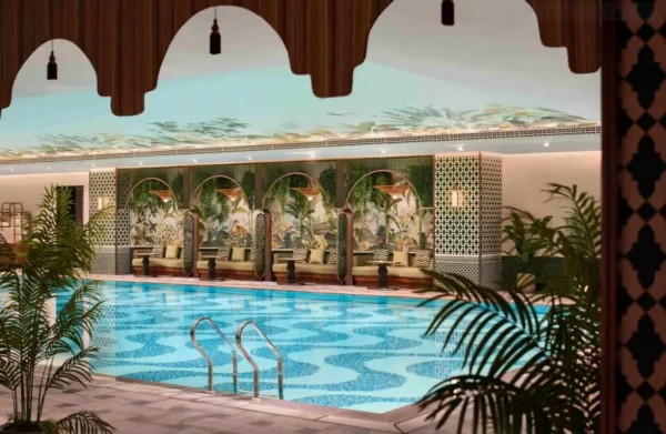 Indoor luxury swimming pool at Shangri-La Kunming with tropical-inspired decor, mosaic tiles and elegant lounge seating