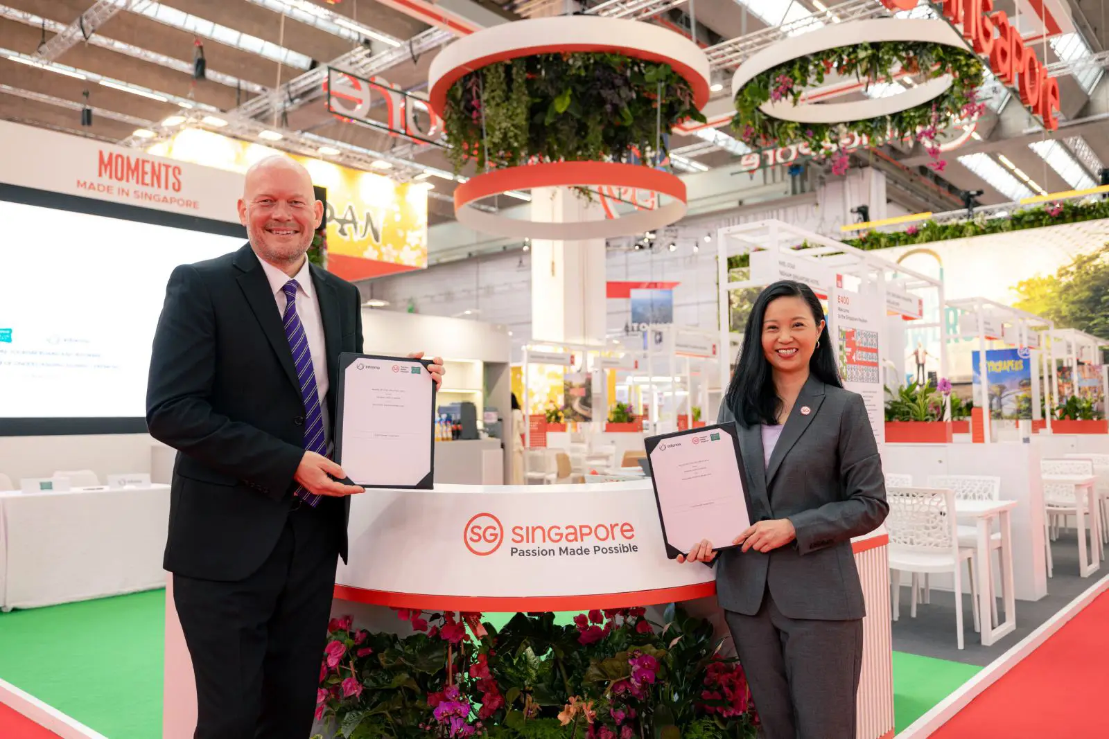 Singapore Named Top Meeting Destination In Asia Pacific, Raises The Bar For Global Business Events 3 Singapore Tourism Board and Informa representatives hold signed MoU documents at the Singapore pavilion during a trade show