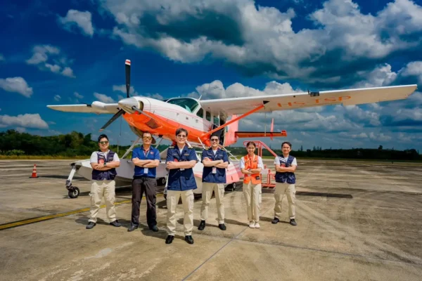 Thai Seaplane crew standing in front of a seaplane aircraft at an airport apron in Thailand ahead of planned Phuket island flights