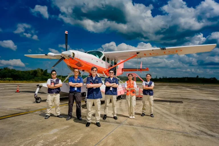 Thai Seaplane crew standing in front of a seaplane aircraft at an airport apron in Thailand ahead of planned Phuket island flights