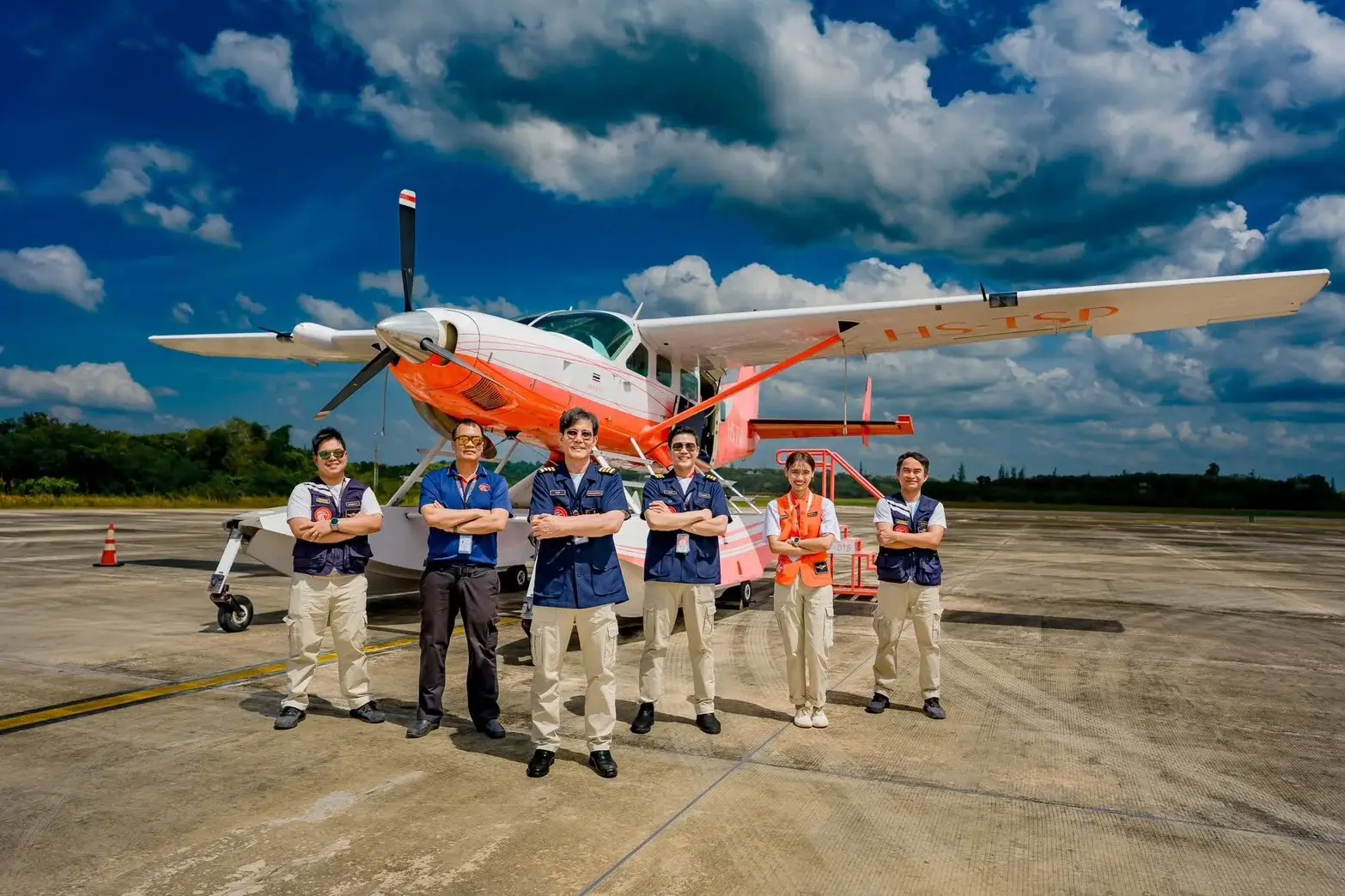 Thai Seaplane crew standing in front of a seaplane aircraft at an airport apron in Thailand ahead of planned Phuket island flights