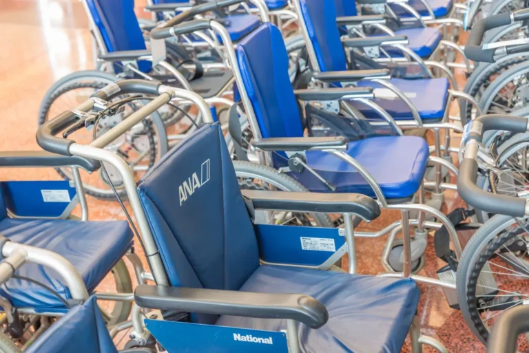 Row of ANA-branded blue wheelchairs available for passenger use at a Japanese airport
