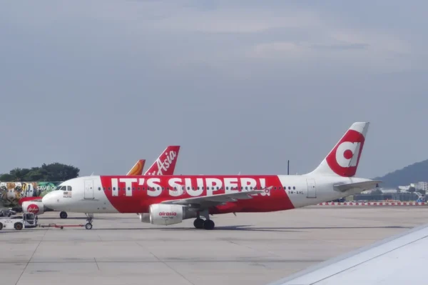 AirAsia Airbus aircraft with “It’s Super” promotional livery parked on the apron at Penang International Airport in Malaysia