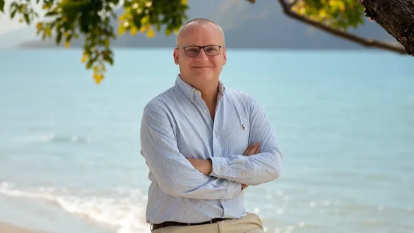 Erik Billgren, General Manager of Anantara Koh Yao Yai Resort and Villas, standing on the resort beach with turquoise sea in the background