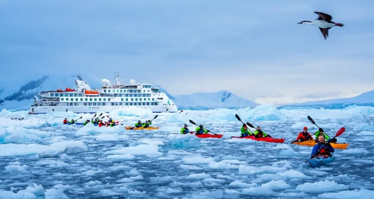 Transportation 10 Kayakers explore Antarctic ice fields alongside an Aurora Expeditions vessel during a polar expedition cruise