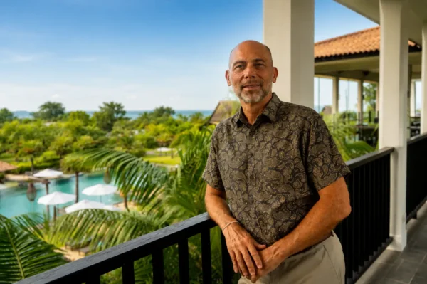Portrait of Hervé Duboscq at Anantara Desaru Coast Resort & Villas overlooking the resort grounds and pool