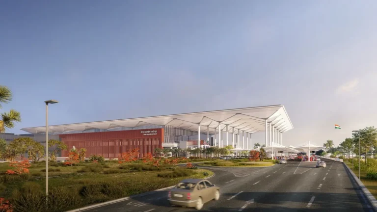 Noida International Airport terminal building exterior with curved white canopy roof