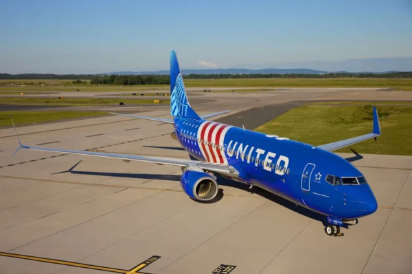 Home 2 United Airlines Boeing 737-800 featuring the special Stars and Stripes livery commemorating America's 250th anniversary, parked on an airport apron.