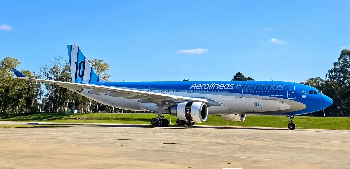 Aerolíneas Argentinas Airbus A330 featuring Lionel Messi’s number 10 livery parked on the tarmac under a clear blue sky.