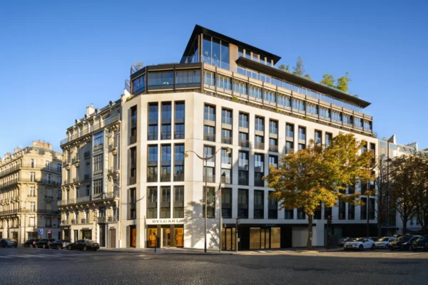 Exterior facade of the Bvlgari Hotel Paris on a street corner under a clear blue sky