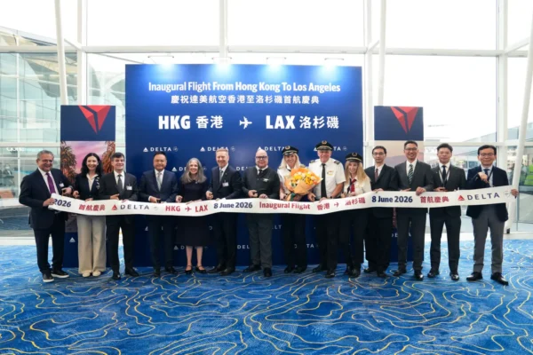 Delta executives and flight crew cut a ribbon at Hong Kong International Airport for the inaugural Hong Kong to Los Angeles flight on 8 June 2026