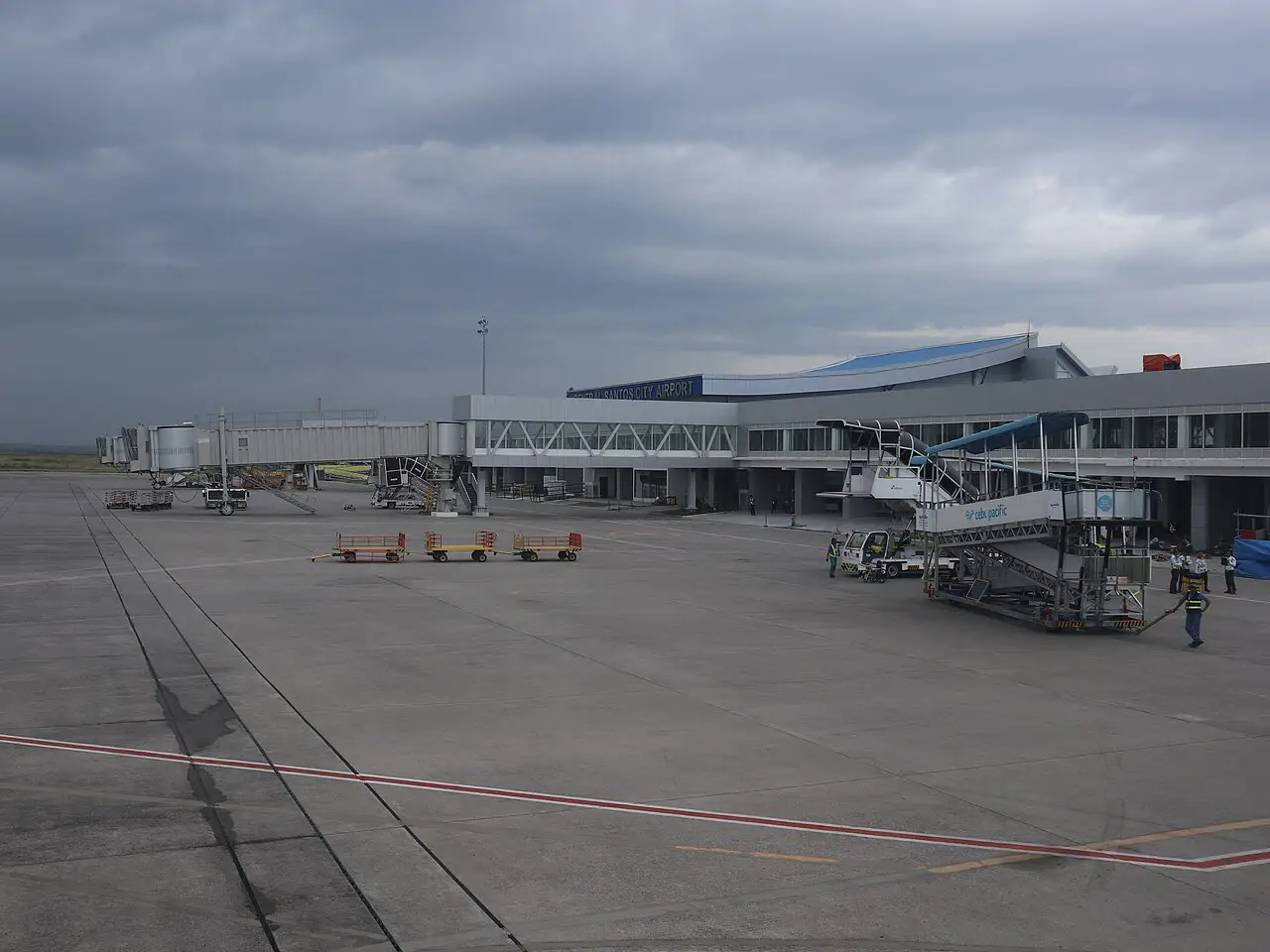 Philippines Earthquake Shuts General Santos Airport 9 View across the apron of General Santos International Airport in Mindanao, showing the terminal building, jet bridges and a Cebu Pacific boarding stairway under an overcast sky
