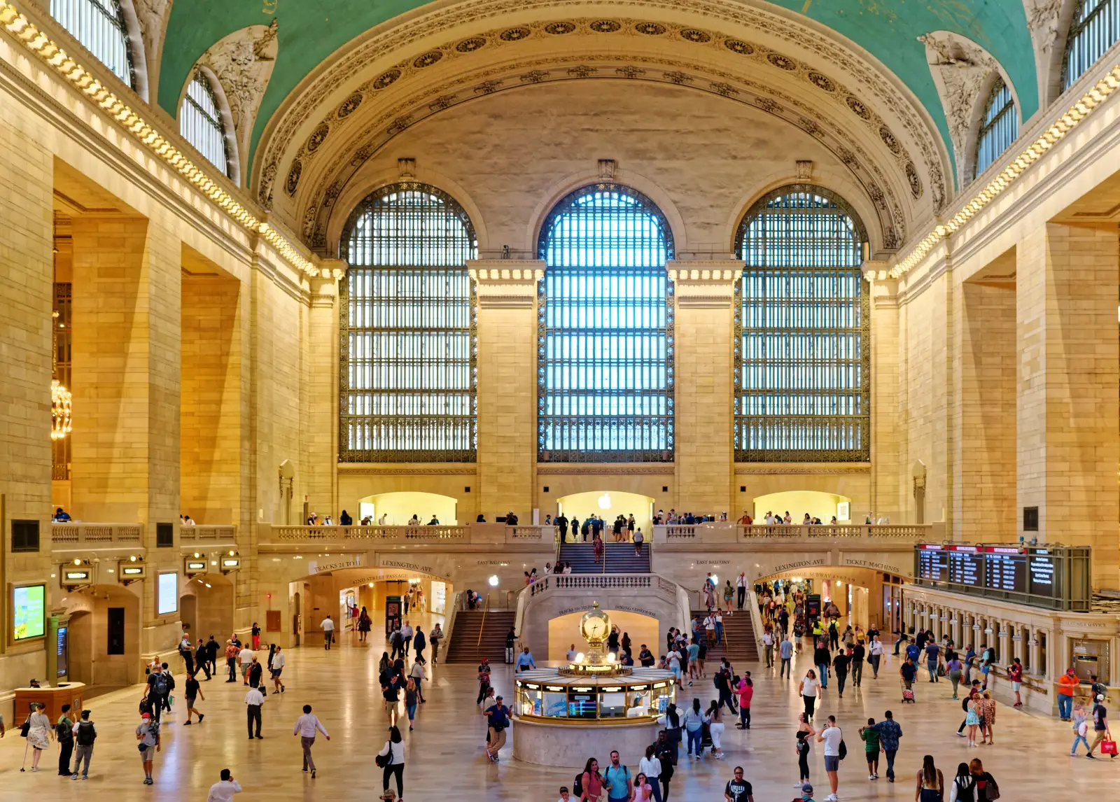 Interior view of Grand Central Terminal in New York City with travelers walking through the historic main concourse