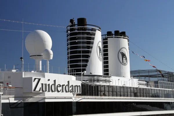 Upper deck of Holland America Line's Zuiderdam showing the ship name and funnels